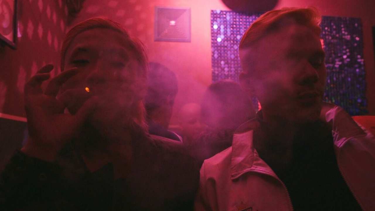 two people smoking in a bar